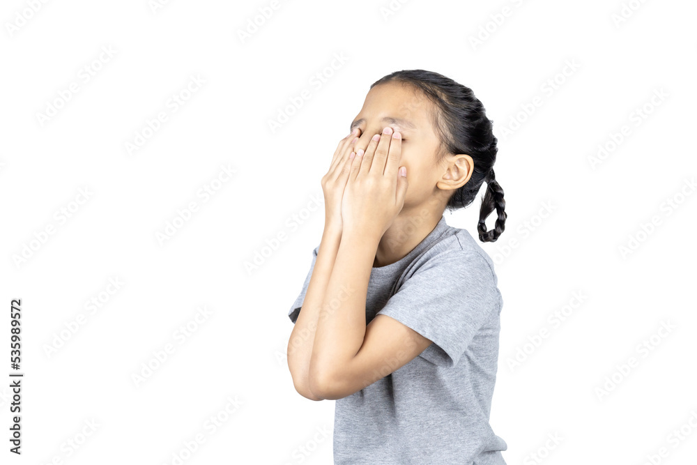 Asian little girl covers her face with her hand with clipping path. Asian little girl covers her face with her hand with clipping path.