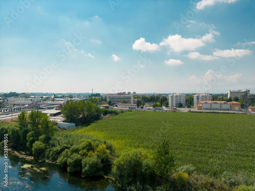 Aerial photo of vegetable field by the roadside leading to the city