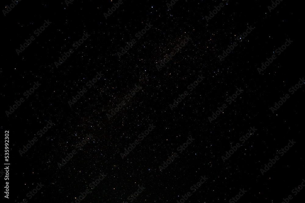 Many stars on black sky at night. A real dark night sky with plenty of stars. Night sky background 