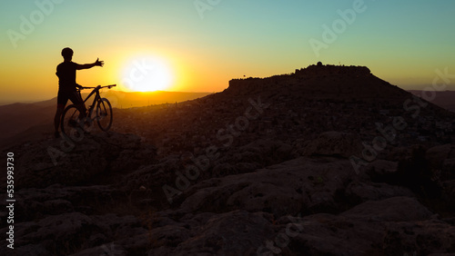 Cycling in harsh conditions, enjoying the magnificent view and successful cyclist