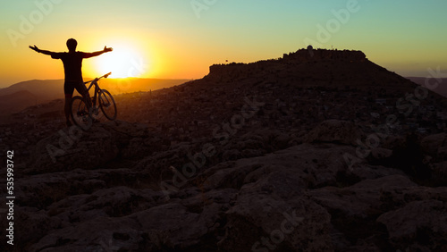 Cycling in harsh conditions, enjoying the magnificent view and successful cyclist