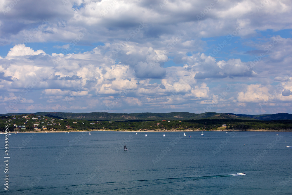 Sailboats and motorboats on the clear blue water