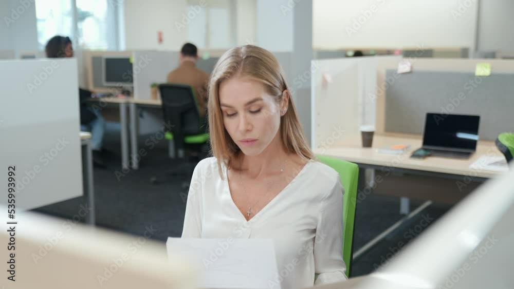 International office, managers team at work, a focused female accountant works with financial documents, open space. International office, managers team at work, a focused female accountant works with financial documents, open space.