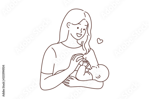 Happy woman feeding infant 
