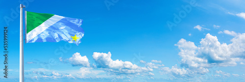 Mato Grosso do Sul - state of Brazil, flag waving on a blue sky in beautiful clouds - Horizontal banner photo