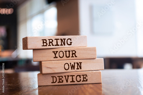 Wooden blocks with words 'Bring Your Own Device'. photo