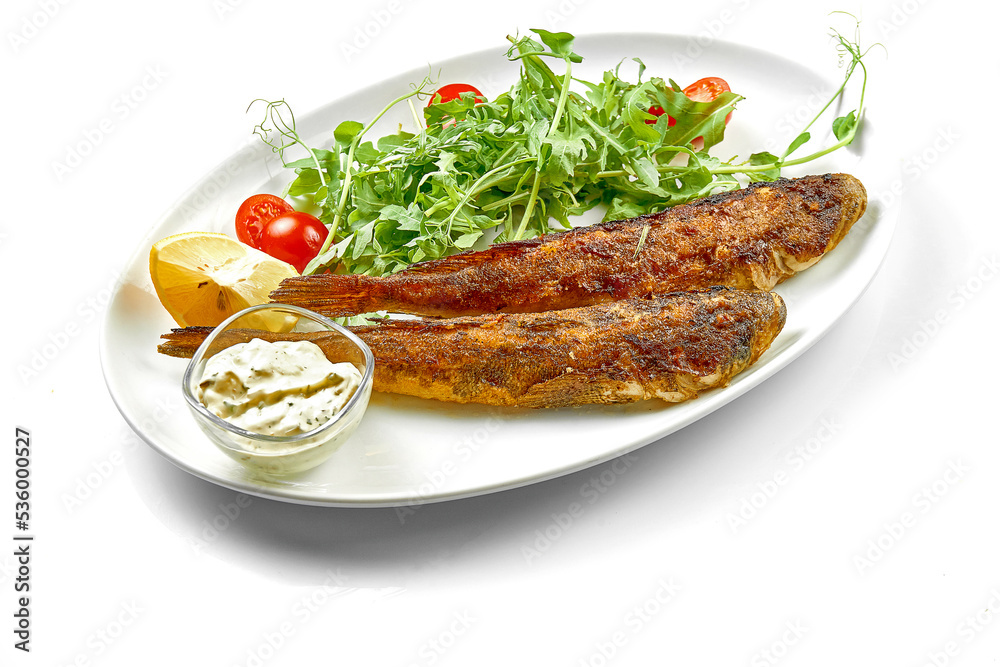 Fried gobies in a white plate. Close-up, selective focus. White background Fried gobies in a white plate. Close-up, selective focus. White background