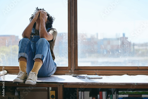 Burnout, anxiety and fatigue creative student frustrated lack of inspiration, studying or learning problem in university classroom. College woman by window crying, stress or mental health depression