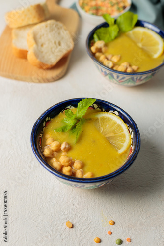 Vegetarian soup of lentils and chickpeas with mint and lemon. Close-up on a light background