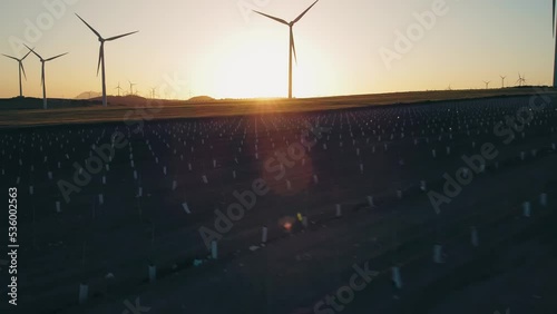 Array of Wind Turbines on Countryside Field at Sunset, Renewable Energy Concept, Drone Shot photo