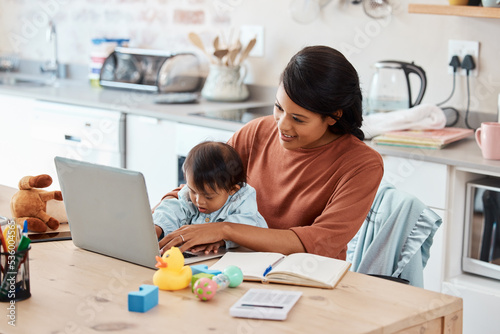 Baby, laptop and mother work from home in kitchen for financial, email or internet. Technology, lifestyle or learning with mom and child at family home office for remote, online and career success photo