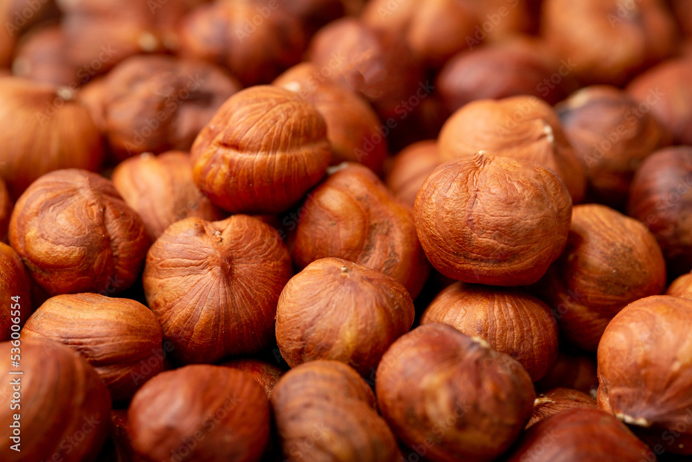 Heap of hazelnuts close-up. Peeled nuts. Hazelnut isolated on white background. Heap of hazelnuts close-up. Peeled nuts. Hazelnut isolated on white background.