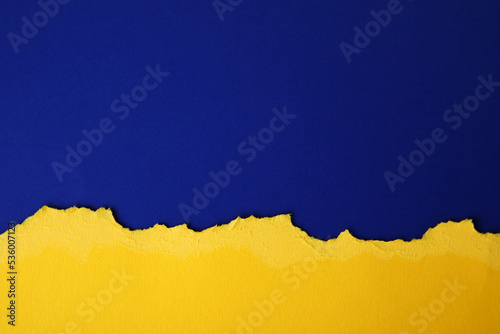 yellow and blue Hole in the paper with torn sides. concept war in Ukraine