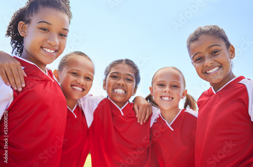 Girl team, in soccer and happy with teamwork and team building at stadium. Friends, diversity and collaboration in sports motivation for fitness, bonding, exercise and training. Smile in portrait.