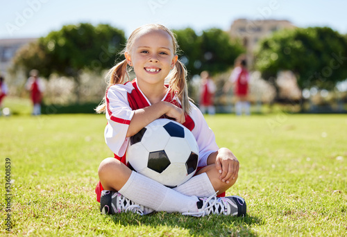Soccer ball, sports girl and field sitting, training for youth competition match playing at stadium grass. Portrait, young athlete or player enjoy youth football world cup championship game at club