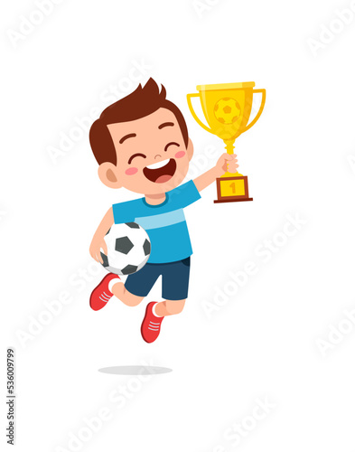 little kid win soccer competition and holding trophy
