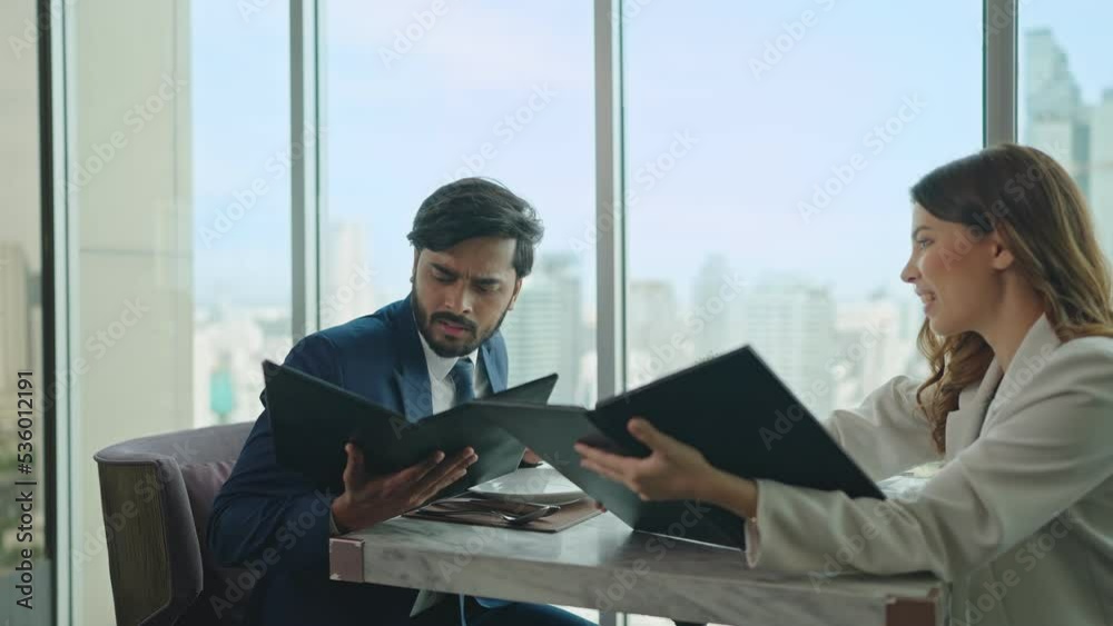 Happy business couple dating talking and help each other choose a menu from the menu book at restaurant Happy business couple dating talking and help each other choose a menu from the menu book at restaurant