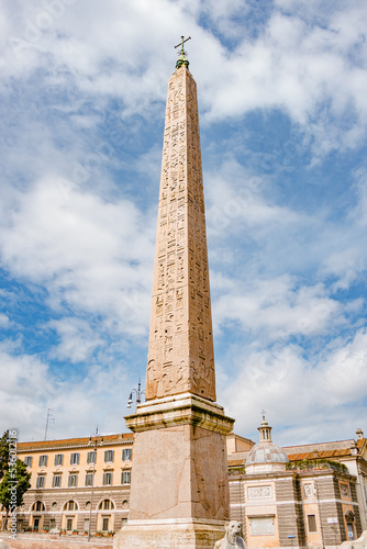 Ancient Egyptian obelisk known as Flaminian Obelisk at Piazza del Popolo in Rome, Italy, It holds Christian cross on the top and many Egyptian hieroglyphs.