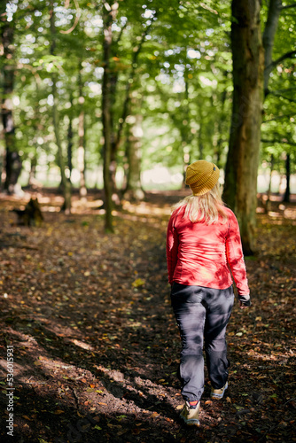 young female walking in forest