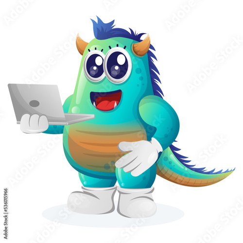 Cute blue monster working using a laptop