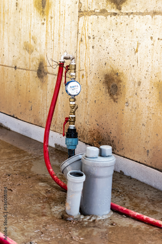 Sewer pipes in home basement. System of gray sanitary pipes in old house. Sewer pipes in home basement. System of gray sanitary pipes in old house.