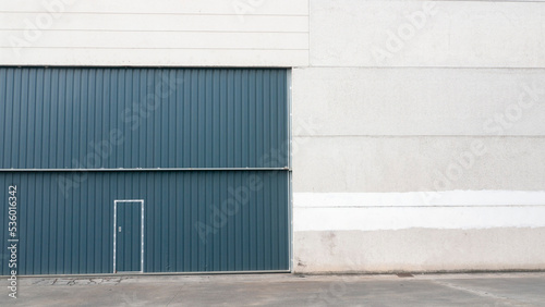 Puerta metálica azul en nave industrial de hormigón  © Darío Peña