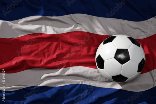 vintage football ball on the waveing national flag of costa rica background. 3D illustration