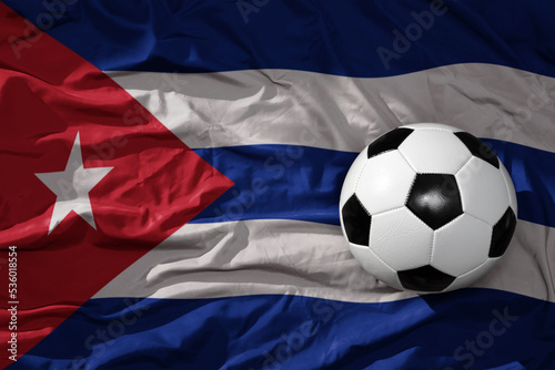 vintage football ball on the waveing national flag of cuba background. 3D illustration