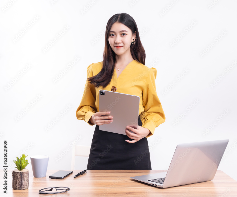 A business woman standing at her desk in a short black dress