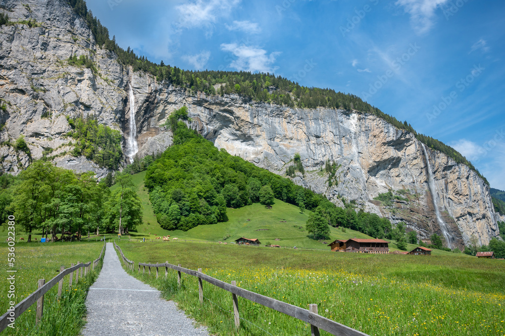 Landscape of Lauterbrunnen valley, the Staubbach Fall and the Lauterbrunnen Wall in Swiss Alps, Switzerland.