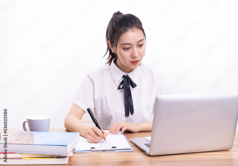 Asian female students taking an online class against a white background Asian female students taking an online class against a white background