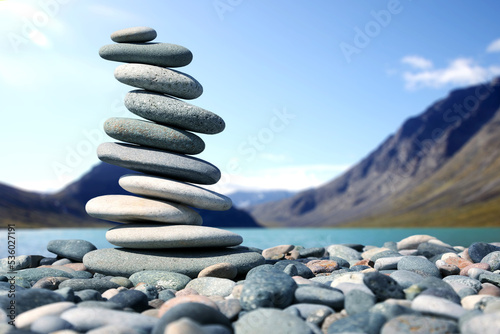 pyramid of smooth stones on the background of a mountain lake. natural balance of life.
