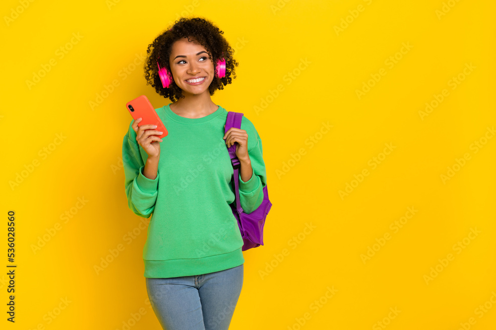Portrait of minded attractive girl look empty space brainstorm hold rucksack isolated on yellow color background Portrait of minded attractive girl look empty space brainstorm hold rucksack isolated on yellow color background