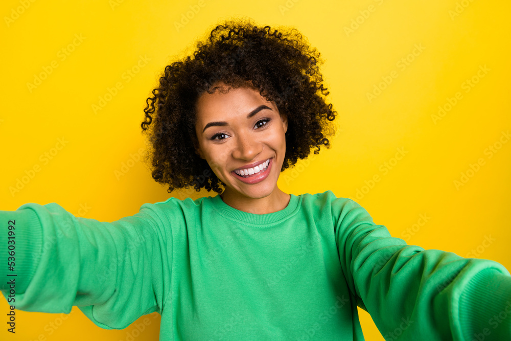 Photo of satisfied glad girl male selfie toothy beaming smile isolated on yellow color background Photo of satisfied glad girl male selfie toothy beaming smile isolated on yellow color background