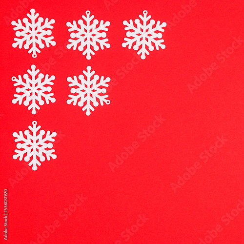 Snow flakes in corner of red background with copy space. Fat lay