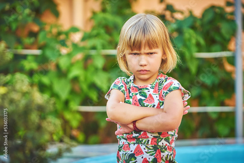 Angry little girl outdoors photo