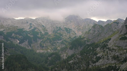 Wallpaper Mural 4k tight video filmed on a gimbal up the Slovenian mountains in the Alps forward movement, behind bushes and a big mountain in the background filmed at sunset and clouds in the sky Torontodigital.ca