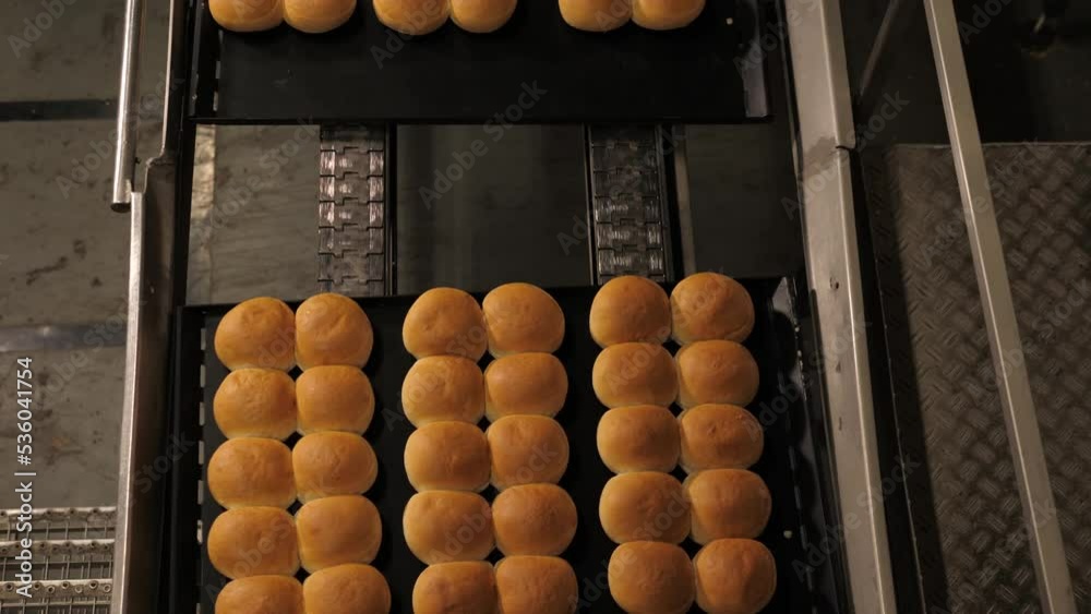Bread and rolls out of the oven on a baking plate in a bakery factory, topdown shot Bread and rolls out of the oven on a baking plate in a bakery factory, topdown shot