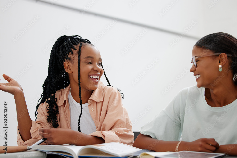 Student, education and university with girl friends learning in class while laughing or joking at their desk. Scholarship, university and study with a black woman pupil and friend in college to learn Student, education and university with girl friends learning in class while laughing or joking at their desk. Scholarship, university and study with a black woman pupil and friend in college to learn
