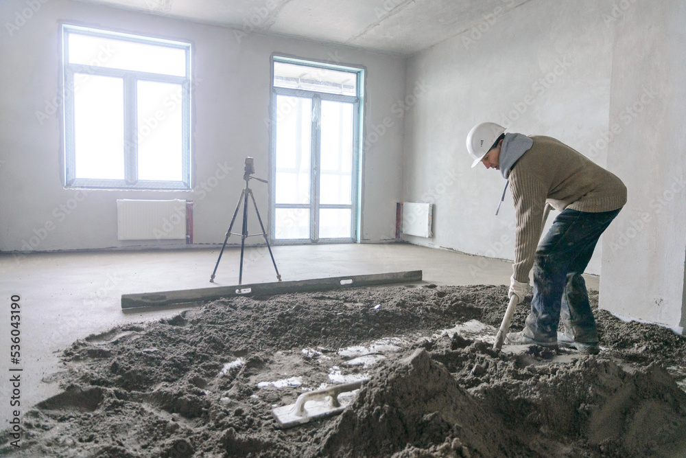 A builder in work clothes is doing his job A builder in work clothes is doing his job