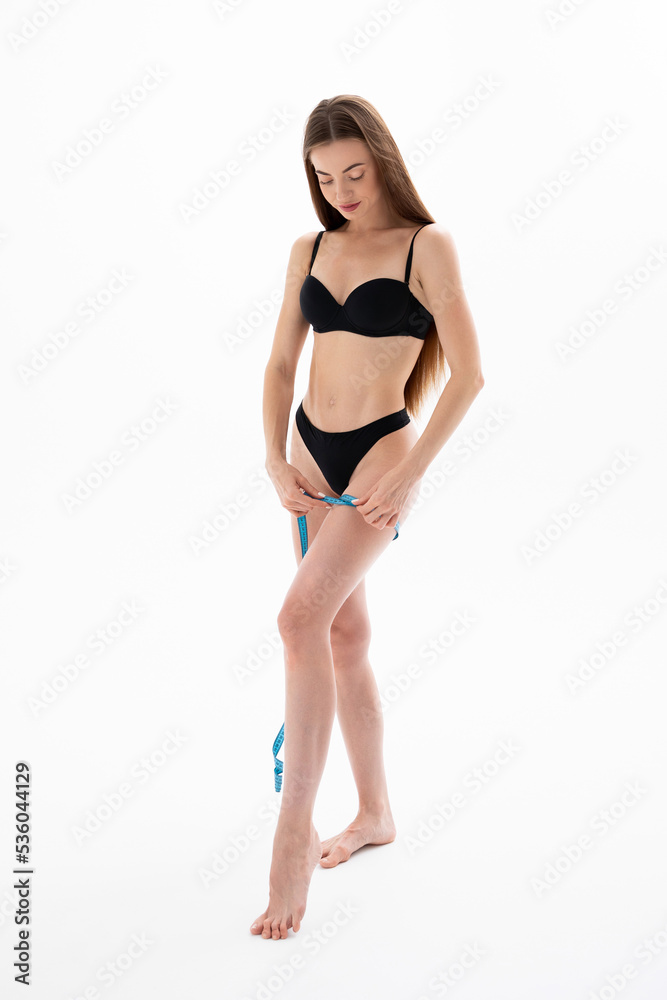 Girl measures her body size with measuring tape Girl measures her body size with measuring tape
