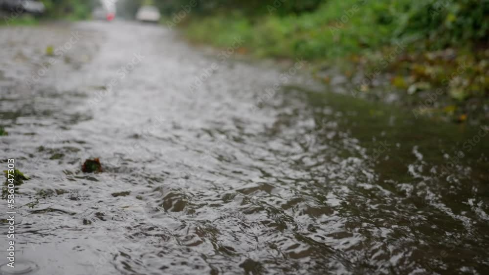 Water flows and splashes after a heavy rain, an overabundance of water. flood Water flows and splashes after a heavy rain, an overabundance of water. flood