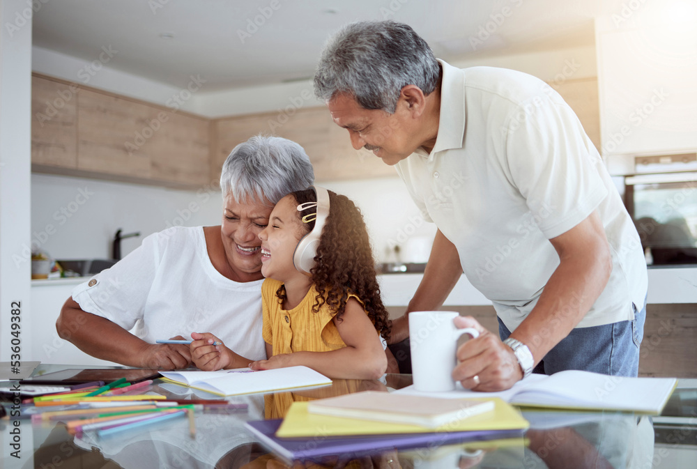 Family, learning and education with a girl and grandparents laughing while learning or doing homework at home. Children, study and school with a female kid, senior man and woman writing or drawing Family, learning and education with a girl and grandparents laughing while learning or doing homework at home. Children, study and school with a female kid, senior man and woman writing or drawing