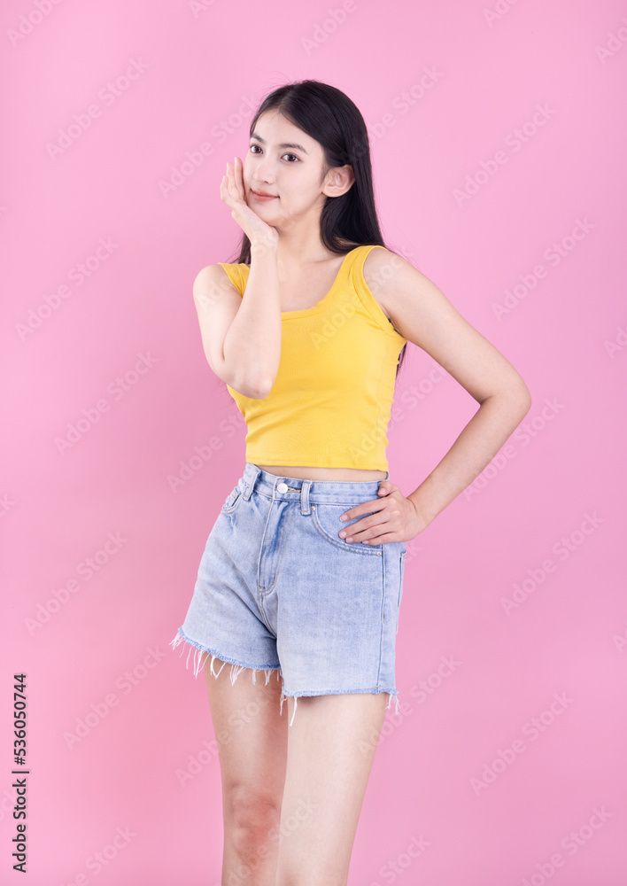 Asian girl in summer dress on pink background Asian girl in summer dress on pink background
