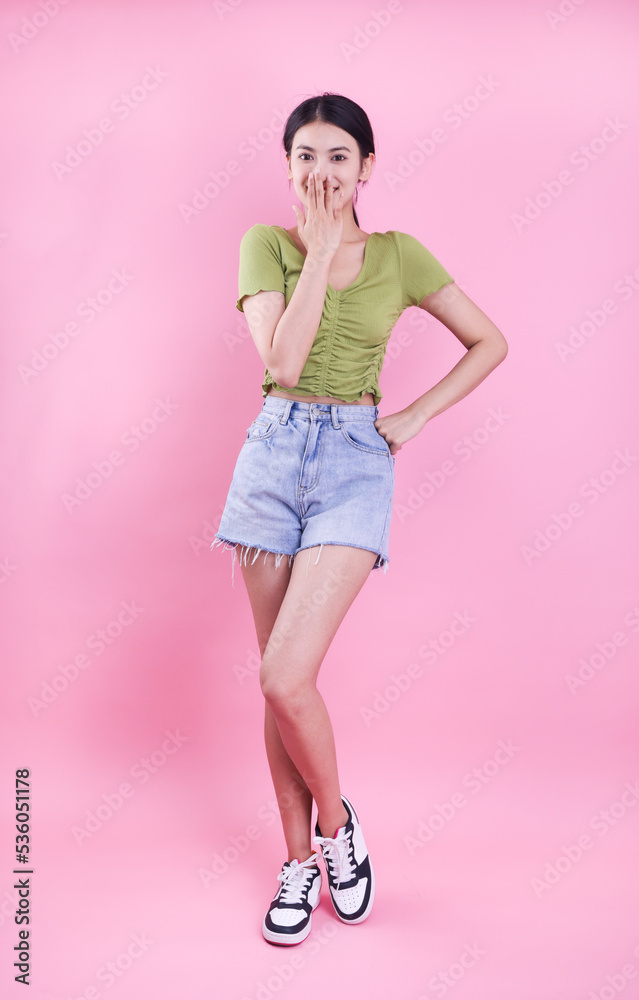 Asian girl in summer dress on pink background Asian girl in summer dress on pink background