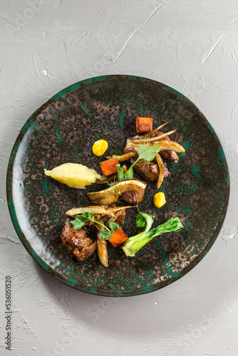 Roasted Fried duck fillet with caramelized onion on brown plate on the table