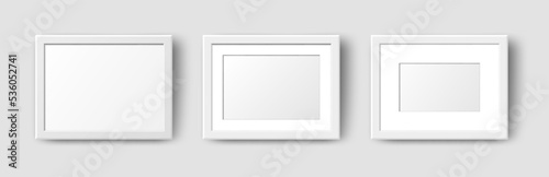 Realistic Horizontal Rectangle Empty Wall Photo Frames set. Vector white picture frame mockup template with shadow on grey background. Mockup for poster, banner, photo gallery, painting, presentation.