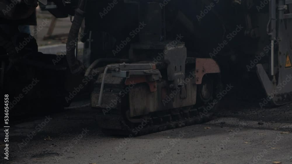 Trucks of road cold milling machine removes old asphalt. Trucks of road cold milling machine removes old asphalt.
