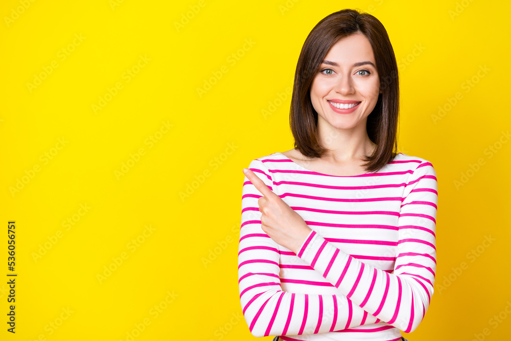 Obraz premium Closeup photo of young attractive smiling woman pointing empty space done teeth clinic isolated on yellow color background
