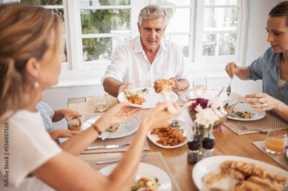 Family, food and eating with a senior man at the dining room table with his relatives for a meal during a visit or celebration event. Happy, together and fresh with a hungry group of people at home Family, food and eating with a senior man at the dining room table with his relatives for a meal during a visit or celebration event. Happy, together and fresh with a hungry group of people at home